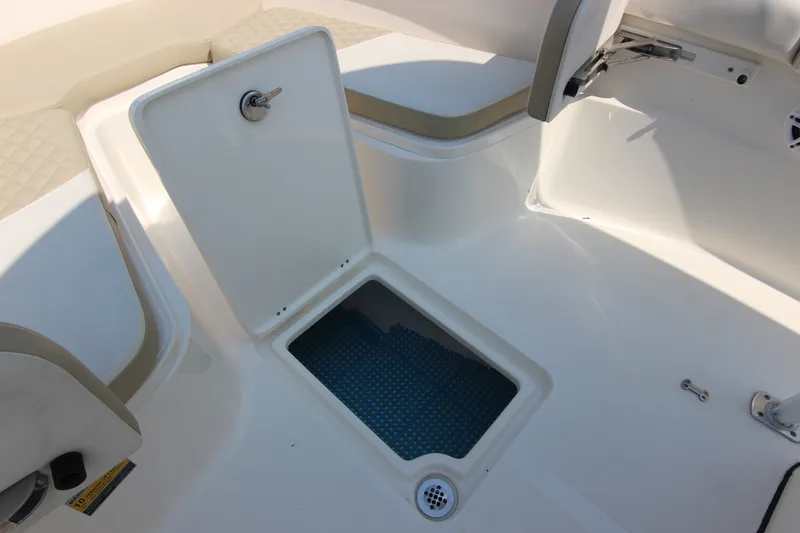Slide: The Image of 2024 Bulls Bay 255 Center Console boat storage compartment open. - 30