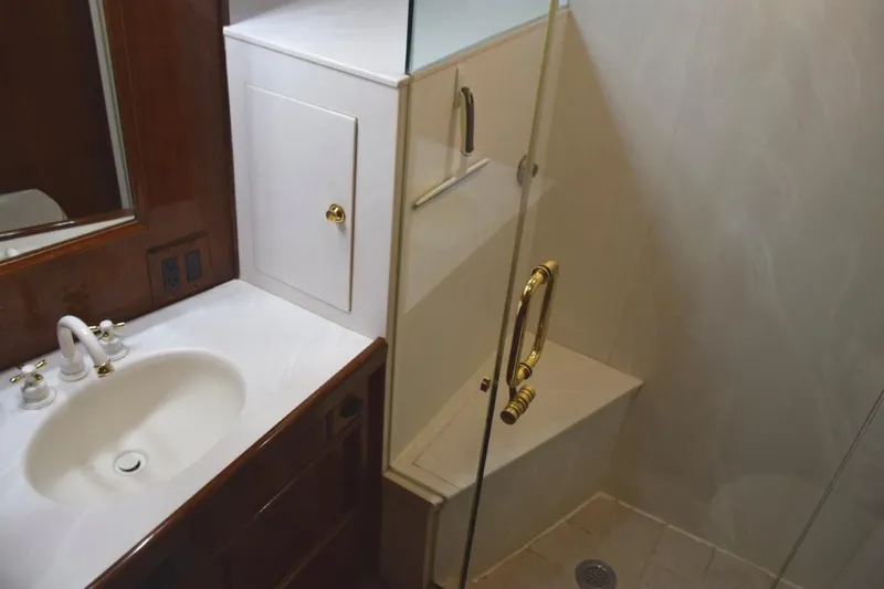 Slide: The Image of Master vanity top with mirrored medicine cabinet and glass shower enclosure with seat. - 53