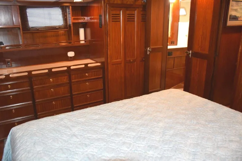 Slide: The Image of Portlights to either side of the stateroom and note abundance of drawers in dresser next to cedar lined hanging closet and head entry door - 52