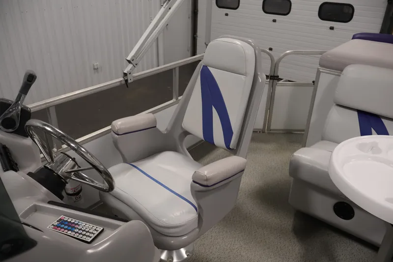 Slide: The Image of Interior of a 2009 Leisurecraft 22 Cruise boat with steering wheel and seating. - 29