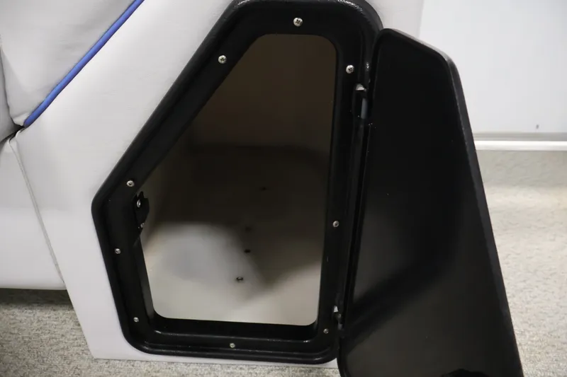 Slide: The Image of Open storage compartment on a 2009 Leisurecraft 22 Cruise boat, featuring black trim and white interior. - 32