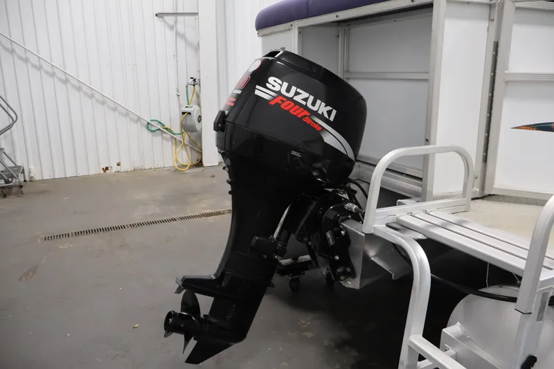 Slide: The Image of 2009 Leisurecraft 22 Cruise with Suzuki four-stroke outboard motor in a garage setting. - 39