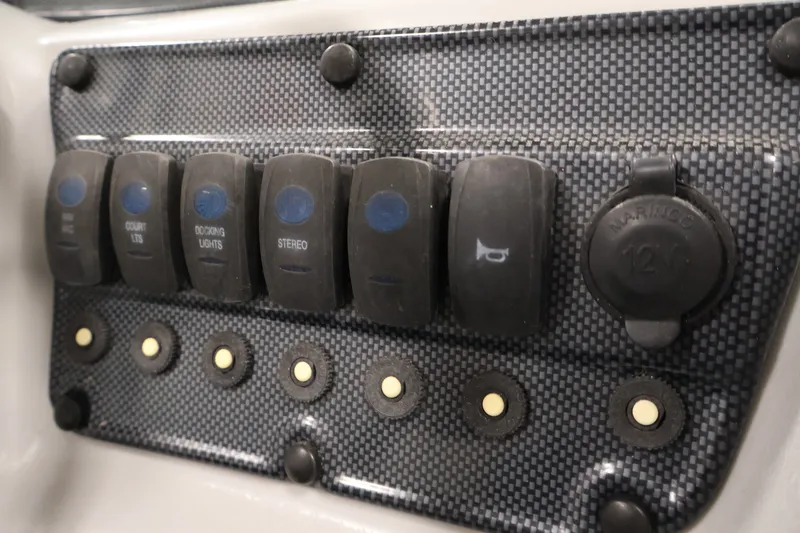Slide: The Image of Control panel of a 2009 Leisurecraft 22 Cruise boat with switches and 12V outlet. - 27