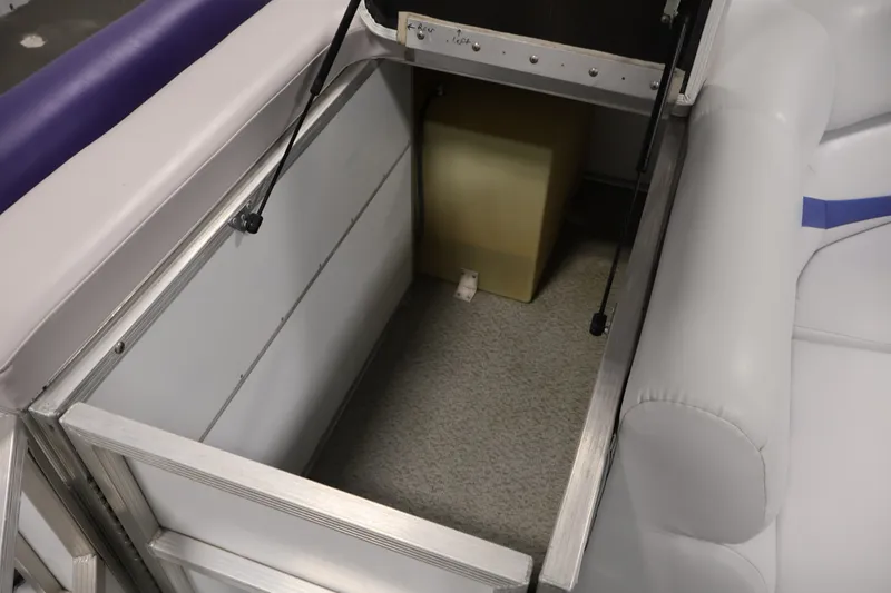 Slide: The Image of Open storage compartment in 2009 Leisurecraft 22 Cruise boat, featuring cushioned seating and metal frame. - 36