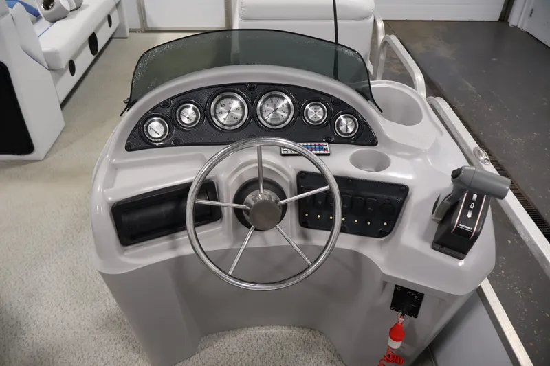 Slide: The Image of Steering console of a 2009 Leisurecraft 22 Cruise boat with gauges and controls. - 22