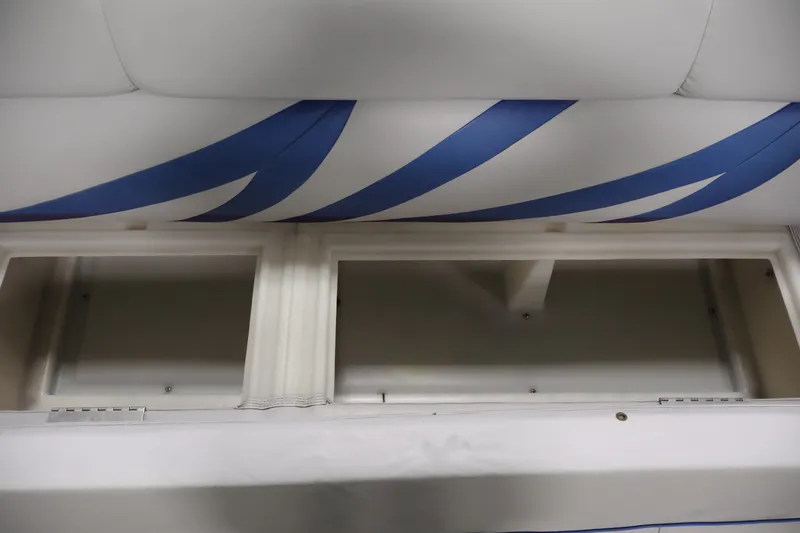 Slide: The Image of Interior storage compartments of a 2009 Leisurecraft 22 Cruise boat with blue accents. - 15