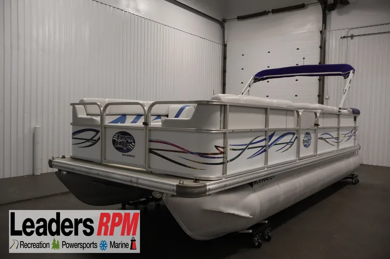 The Image of 2009 Leisurecraft 22 Cruise pontoon boat in indoor showroom, featuring decorative graphics. - 1