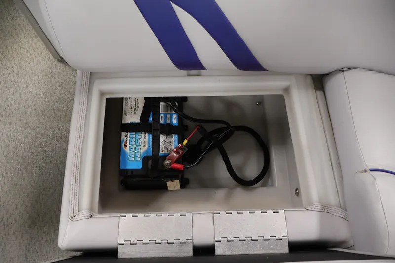 Slide: The Image of Battery compartment of a 2009 Leisurecraft 22 Cruise boat, featuring a marine battery. - 34