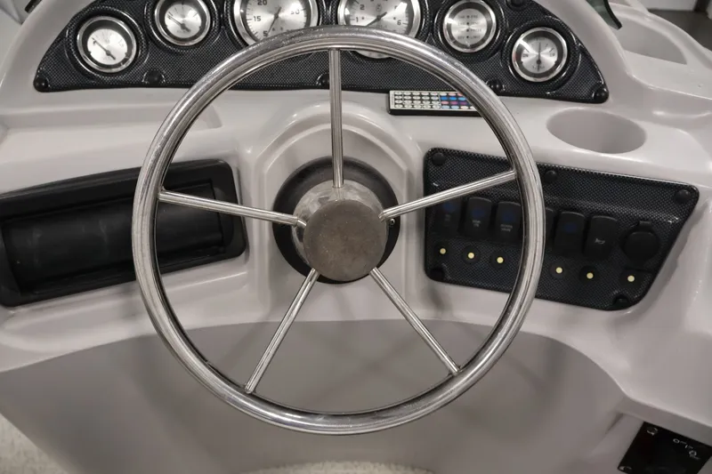 Slide: The Image of Steering wheel and dashboard of 2009 Leisurecraft 22 Cruise boat. - 23