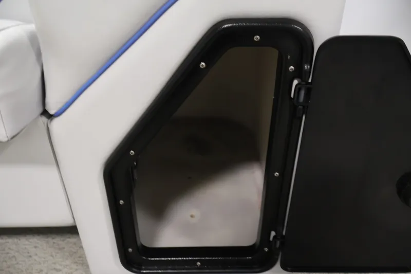 Slide: The Image of Storage compartment on a 2009 Leisurecraft 22 Cruise boat, featuring a black door and white interior. - 18