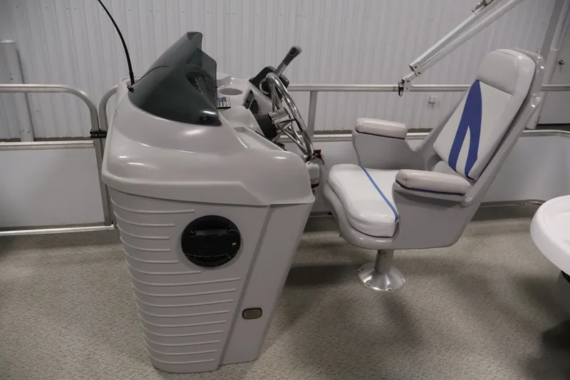 Slide: The Image of 2009 Leisurecraft 22 Cruise boat helm with steering wheel and captain's chair. - 21