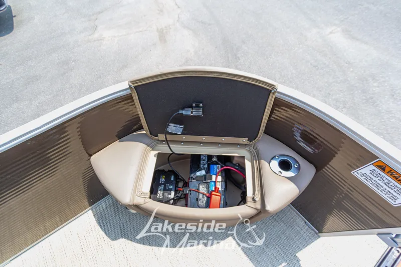 Slide: The Image of 2017 Bennington 22 GFS boat battery compartment with open lid and visible wiring. - 19