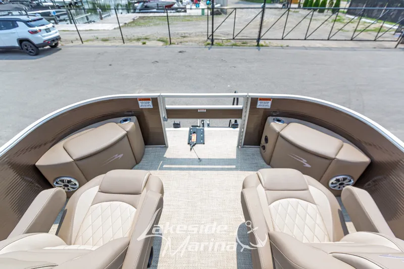 Slide: The Image of 2017 Bennington 22 GFS pontoon boat interior with beige seating and control panel. - 17