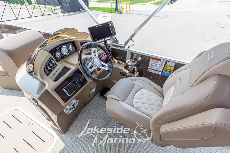 Slide: The Image of Interior of a 2017 Bennington 22 GFS boat with steering wheel and control panel. - 25