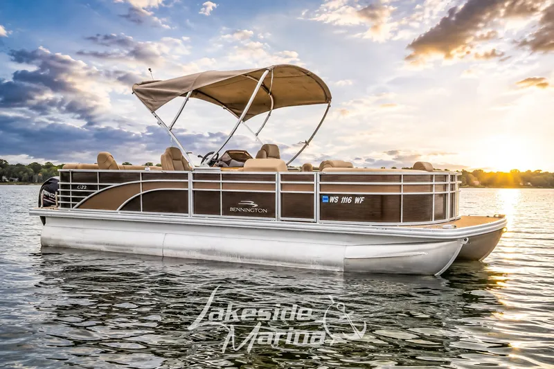 The Image of 2017 Bennington 22 GFS pontoon boat on a serene lake at sunset. - 1