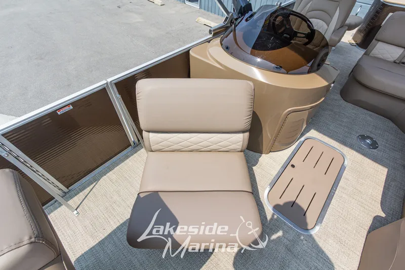 Slide: The Image of 2017 Bennington 22 GFS pontoon boat interior with tan seating and helm. - 21