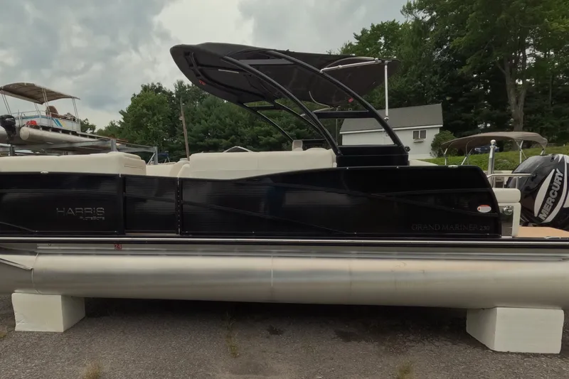 Slide: The Image of 2014 Harris FloteBote Grand Mariner SL 230 pontoon boat on display outdoors. - 2