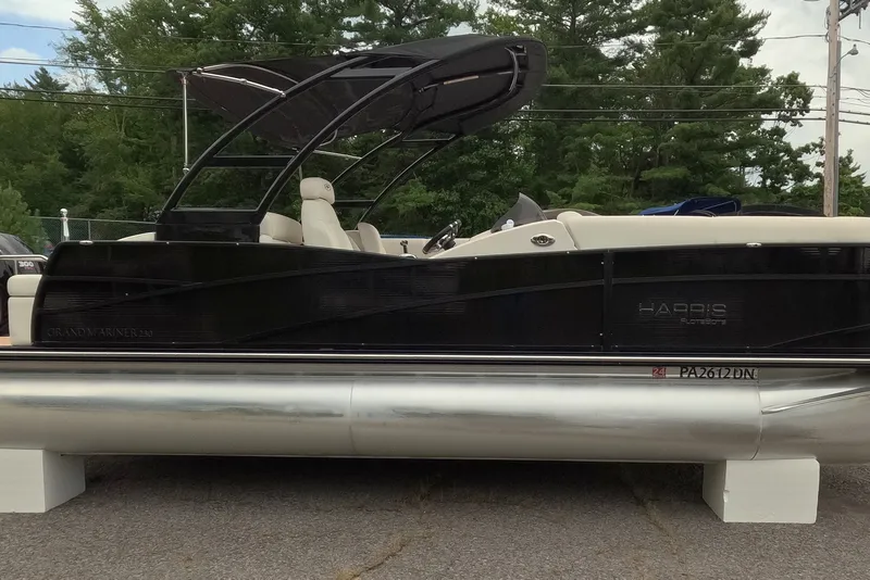 Slide: The Image of 2014 Harris FloteBote Grand Mariner SL 230 pontoon boat with sleek black design. - 10