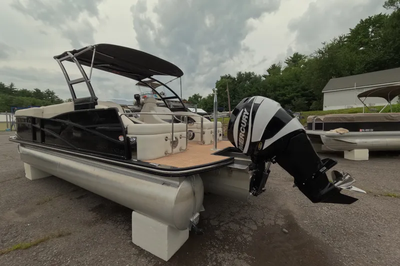 Slide: The Image of 2014 Harris FloteBote Grand Mariner SL 230 pontoon boat with Mercury outboard motor, parked outdoors. - 6