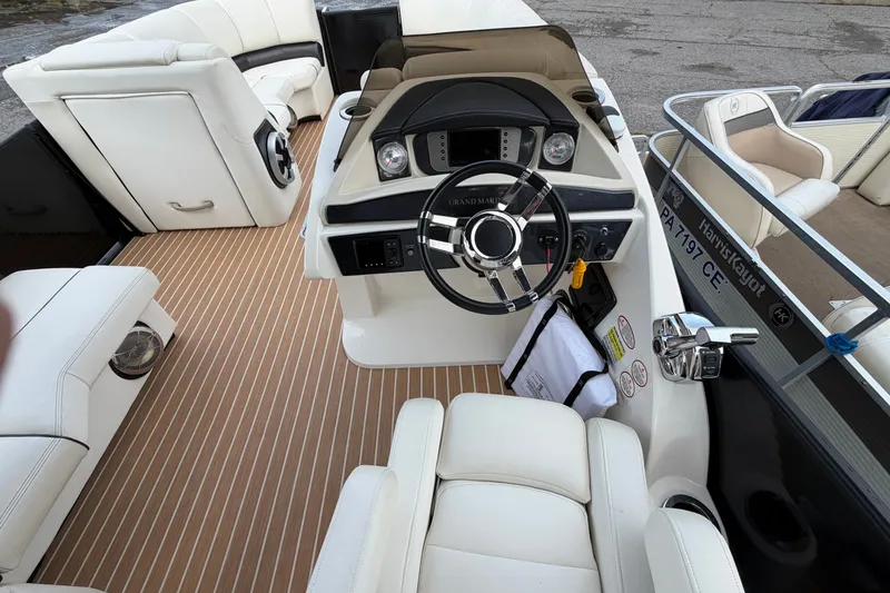 Slide: The Image of 2014 Harris FloteBote Grand Mariner SL 230 interior with sleek helm and luxurious seating. - 14