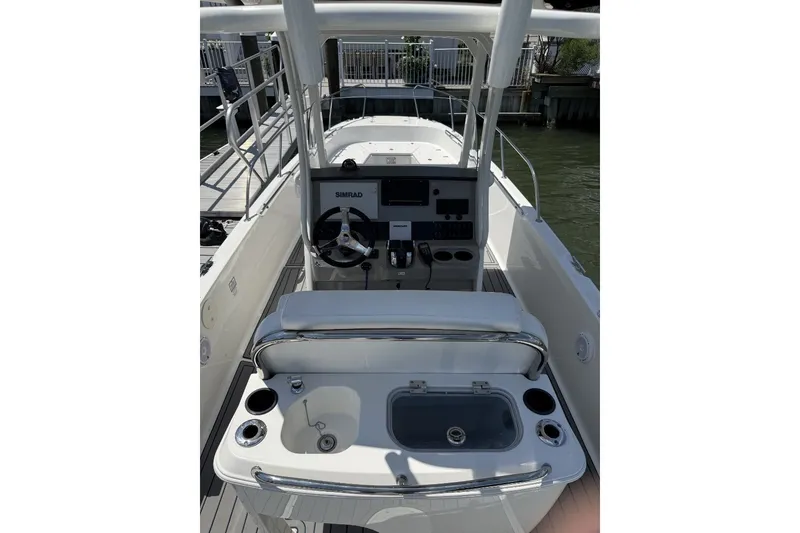 Slide: The Image of 2015 Boston Whaler 270 Dauntless boat interior with helm and seating area. - 16