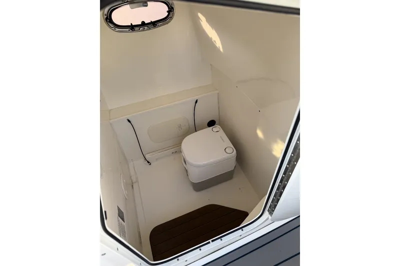 Slide: The Image of Interior of 2015 Boston Whaler 270 Dauntless boat with compact marine toilet. - 18