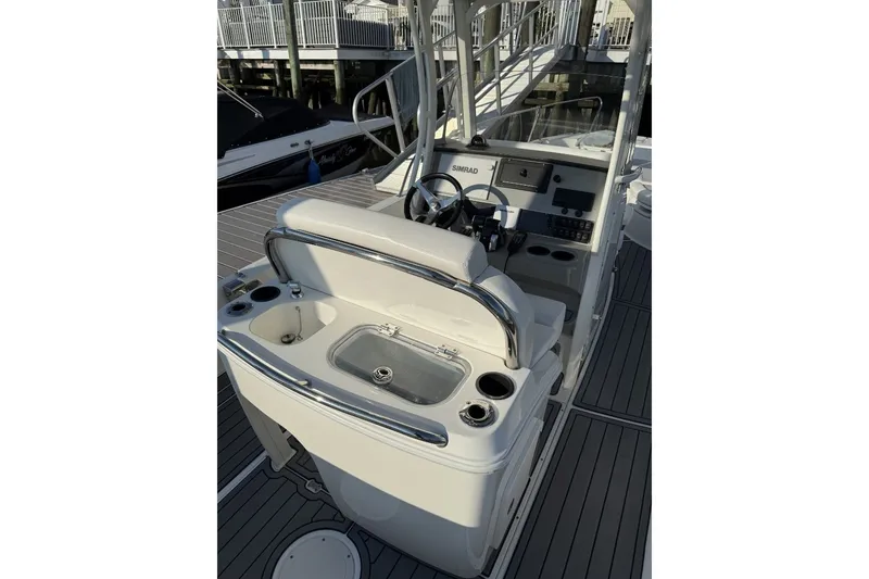 Slide: The Image of 2015 Boston Whaler 270 Dauntless boat interior with helm and seating area. - 14