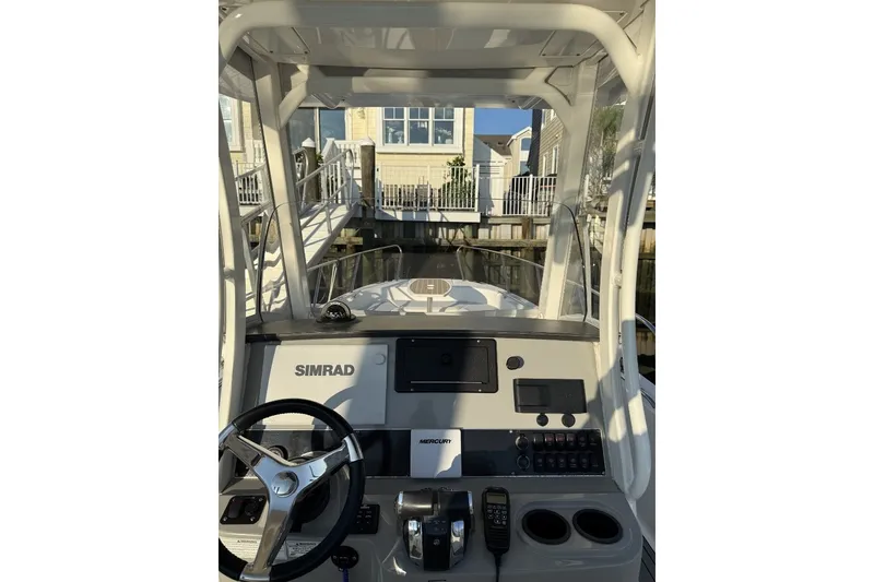 Slide: The Image of 2015 Boston Whaler 270 Dauntless boat dashboard with Simrad electronics and Mercury controls. - 15