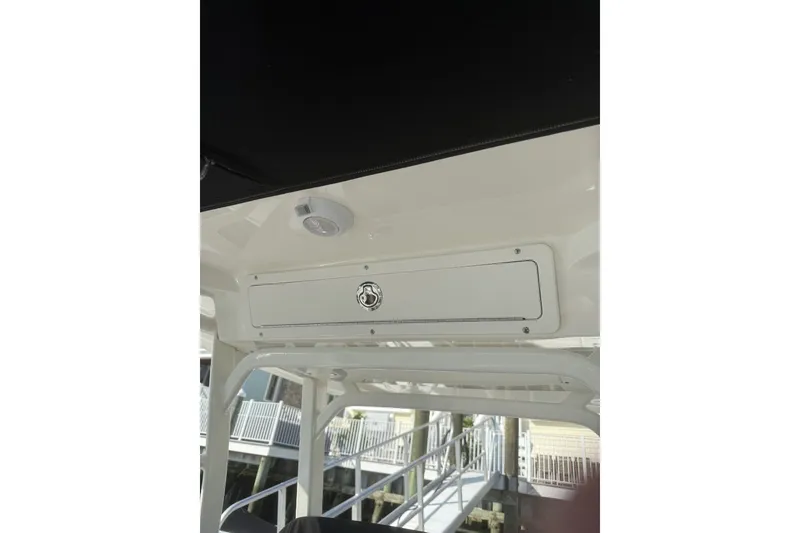 Slide: The Image of 2015 Boston Whaler 270 Dauntless interior detail with storage compartment and speaker. - 17
