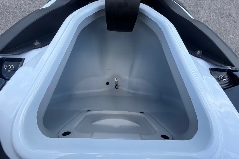 Slide: The Image of An open storage compartment of a 2024 Kawasaki Jetski STX 160X, featuring smooth, light-colored interior walls. - 22
