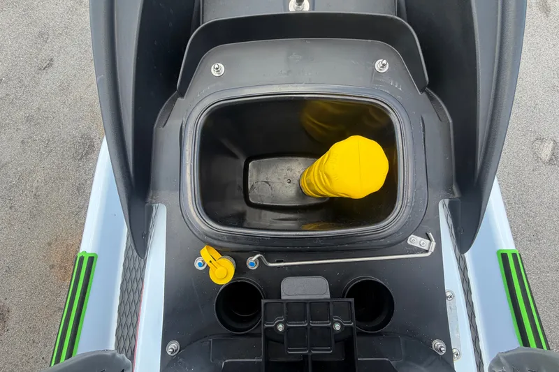 Slide: The Image of 2024 Kawasaki Jetski STX 160X storage compartment with yellow cap, top view. - 27