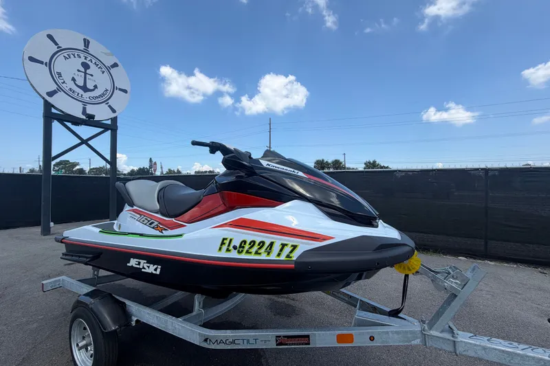 The Image of 2024 Kawasaki Jetski STX 160X on trailer, displayed outdoors under clear sky. - 0