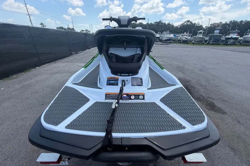 Slide: The Image of 2024 Kawasaki Jetski STX 160X rear view on pavement, showcasing sleek design. - 3