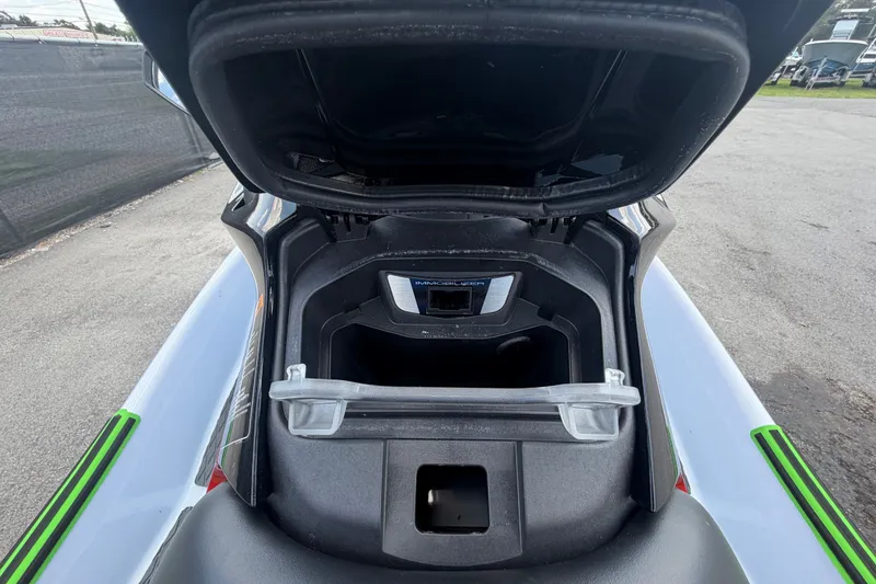 Slide: The Image of 2024 Kawasaki Jetski STX 160X storage compartment open, showcasing interior space. - 14