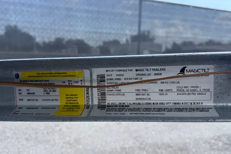Slide: The Image of Label on Magic Tilt trailer showing tire and loading information. - 30