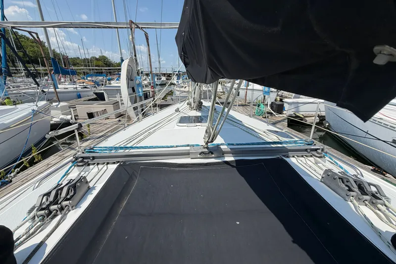 Slide: The Image of 1997 Catalina 320 sailboat docked at marina, showcasing deck and rigging. - 9