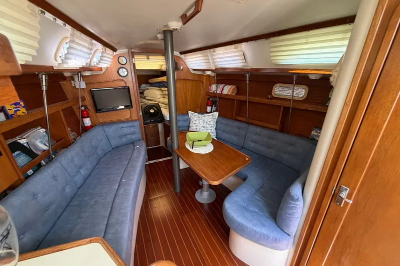 Slide: The Image of Interior of a 1997 Catalina 320 sailboat with cozy seating and wooden finishes. - 19