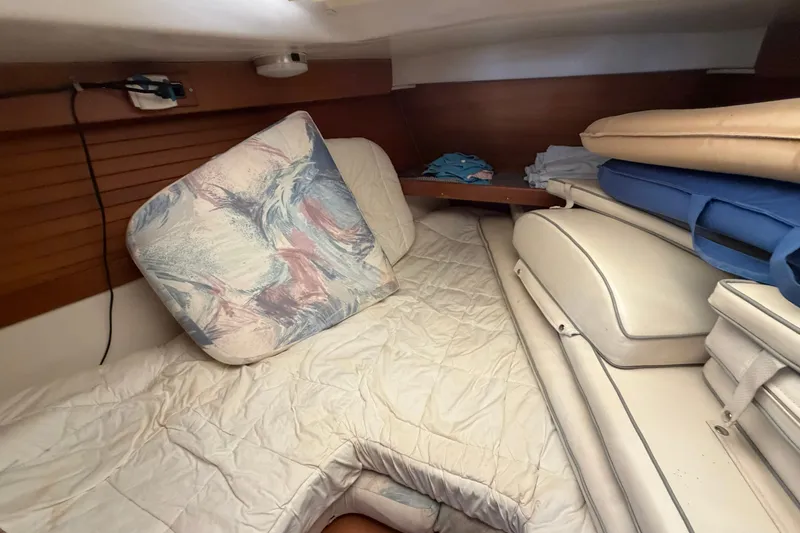 Slide: The Image of Cozy cabin interior of a 1997 Catalina 320 sailboat with cushions and bedding. - 26