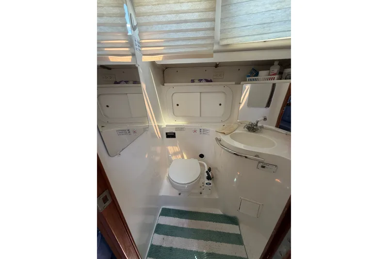 Slide: The Image of Bathroom interior of a 1997 Catalina 320 yacht with toilet and sink. - 23