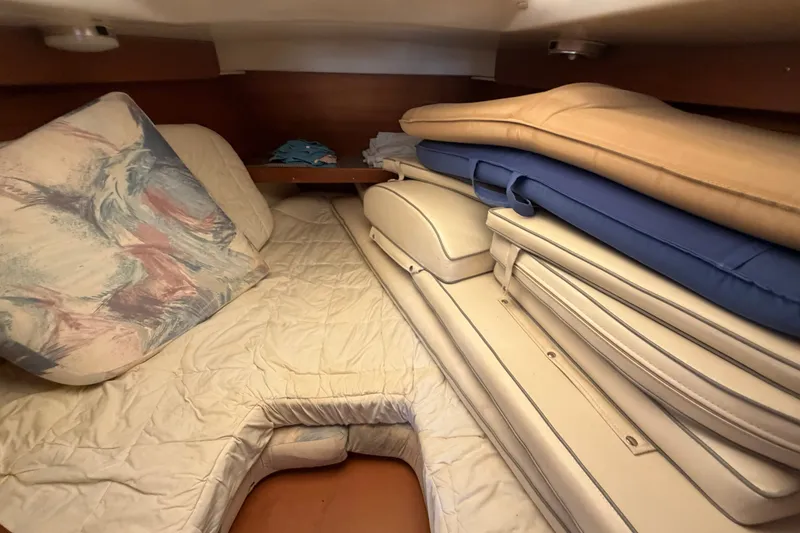 Slide: The Image of Interior cabin of a 1997 Catalina 320 sailboat with stacked cushions. - 25