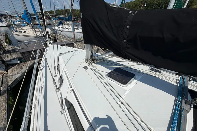 Slide: The Image of 1997 Catalina 320 sailboat docked, showcasing deck and rigging details. - 32