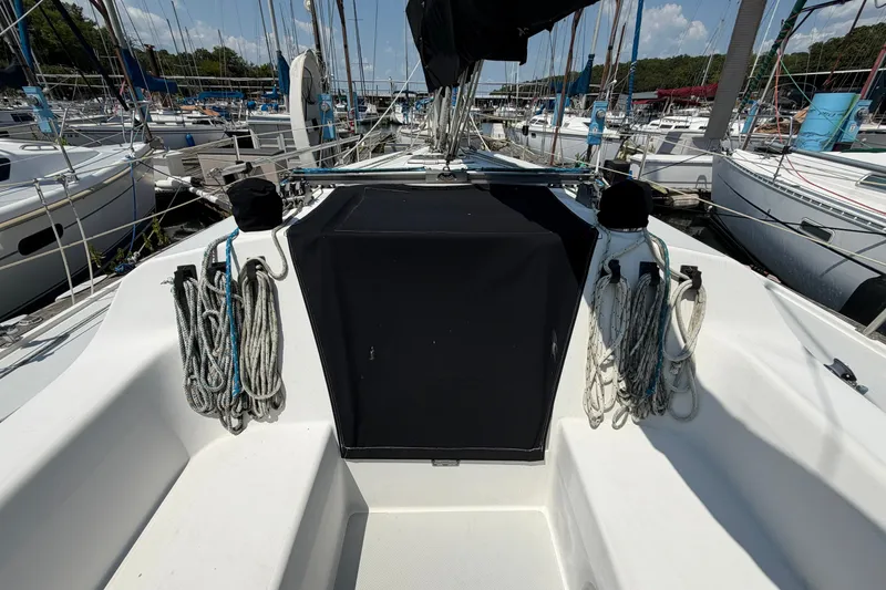 Slide: The Image of Cockpit view of a 1997 Catalina 320 sailboat docked at a marina. - 8