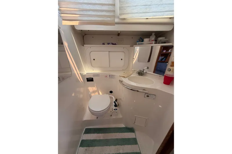 Slide: The Image of Bathroom interior of a 1997 Catalina 320 sailboat with toilet and sink. - 24