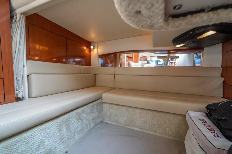 Slide: The Image of Interior of 2007 Sea Ray 340 Sundancer with beige seating and wooden cabinetry. - 58