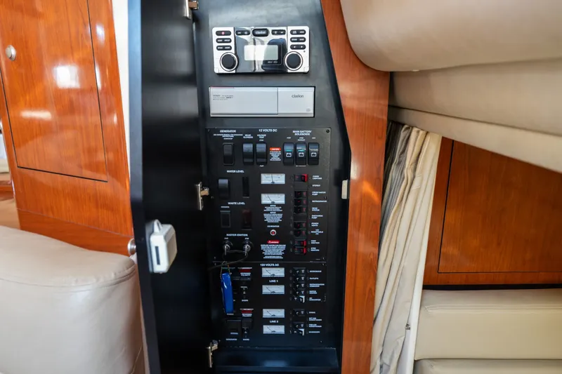 Slide: The Image of Control panel inside a 2007 Sea Ray 340 Sundancer yacht, featuring various switches and controls. - 49