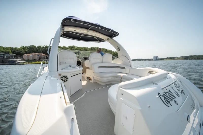 Slide: The Image of 2007 Sea Ray 340 Sundancer yacht cruising on a scenic lake with luxury seating. - 15