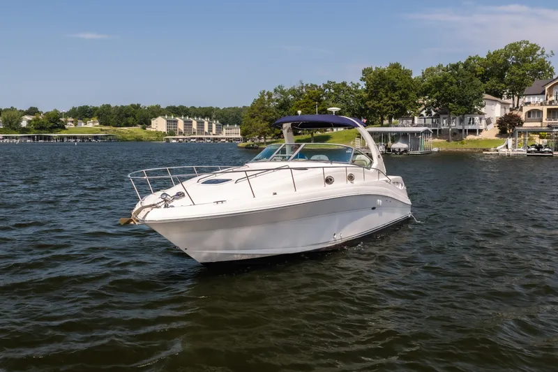 Slide: The Image of 2007 Sea Ray 340 Sundancer yacht cruising on a scenic lake. - 10