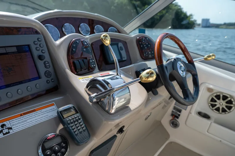Slide: The Image of Cockpit of 2007 Sea Ray 340 Sundancer with steering wheel, controls, and navigation equipment. - 39
