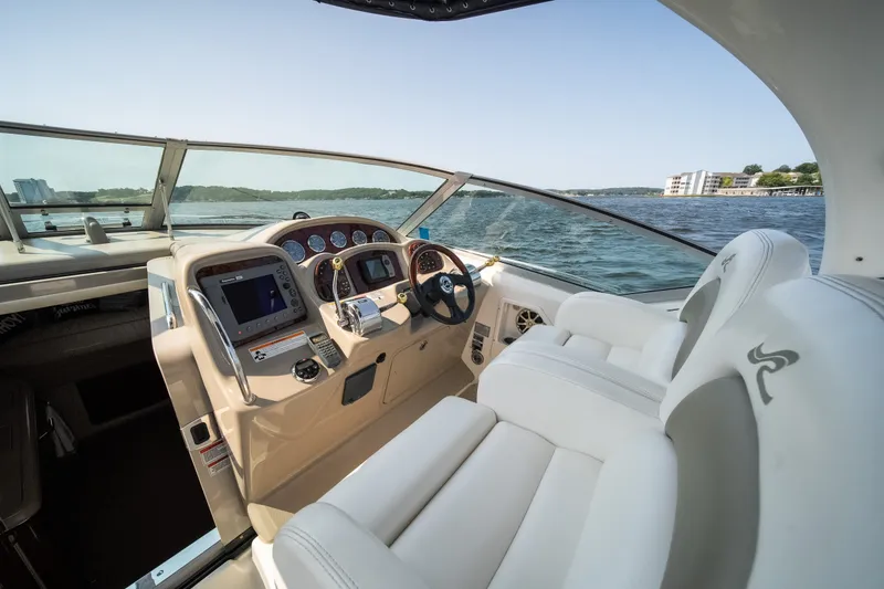 Slide: The Image of 2007 Sea Ray 340 Sundancer cockpit with luxurious seating and modern controls on open water. - 18