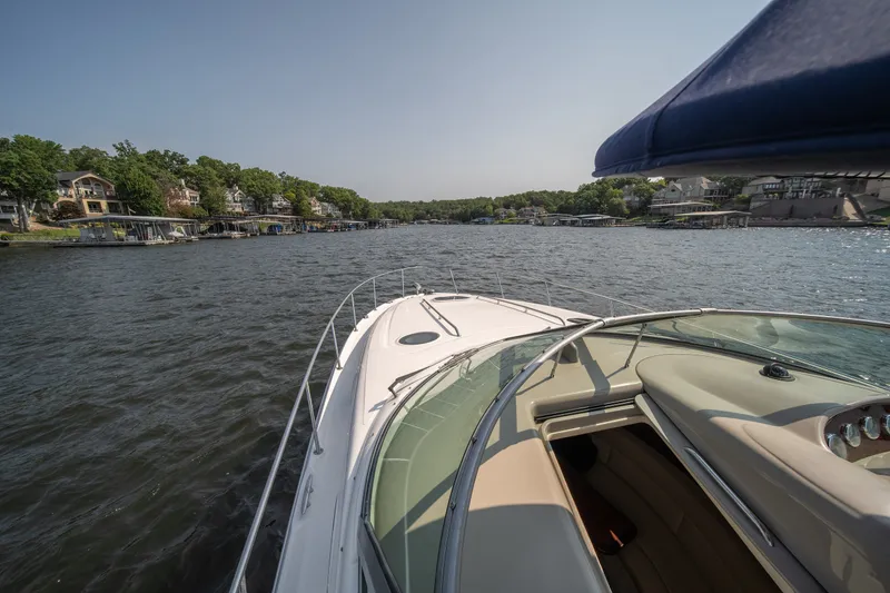 Slide: The Image of 2007 Sea Ray 340 Sundancer cruising on a scenic lake with waterfront homes. - 30